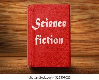 Old Red Science Fiction Book On Wooden Background Closeup