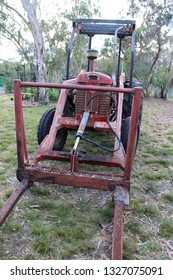 Old Red Tractor With Forks In Paddock, Australia