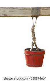 Old Red Wooden Water Bucket Hanging On Wood Beam Isolated On White Background