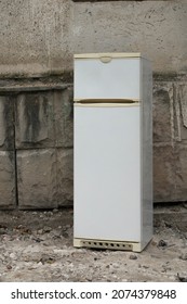 An old refrigerator was thrown away on the street. Close-up.