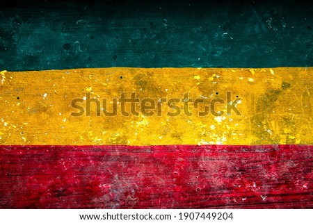 Old Reggae grunge cement wall in Rasta color in red yellow and green with noise and texture. For Graphics Poster Background copy space. Rasta Reggae music Jamaica Style Concept.