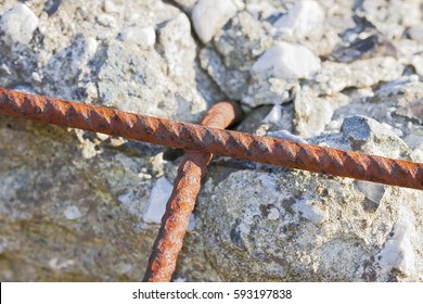 Old reinforced concrete structure with damaged and rusty metallic reinforcement  that must be demolished