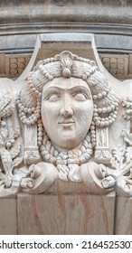Old relief bar, a keystone in a building arch, of a woman face in the historical downtown of Dresden, Germany, details, closeup