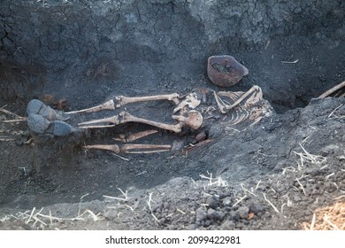 Old remains of a warrior of the Red Army during the Second World War. Soldier found in the trench with helmet and rusty ammunition