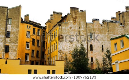 Old residential district in the center of saint petersburg city, russia. Yellow tall buildings with grey aged brick. Historical town cityscape on white background for collage art. 