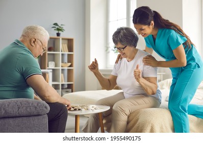 Old retired man and woman enjoy intellectual table games together. Supportive caretaker watching couple of happy senior patients play checkers. Therapy, joy, fun leisure activities in retirement home