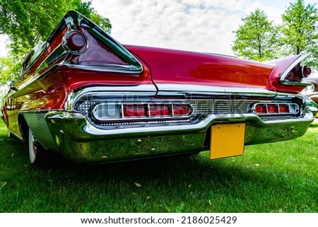Old retro car in bright red color, rear view