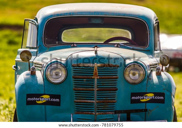 Old retro car with Motorsprot advertising on the\
background of greenery.Photographed near the city of Odessa,\
Ukraine May 11, 2017