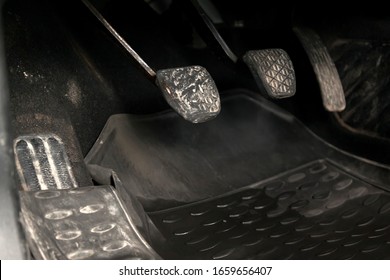 Old Retro Gas Pedals And Brakes In A Car With Mechanical Gear On The Floor With A Rubber Mat. The Concept Of Developing And Accelerating A Business Or Its Braking By Management.