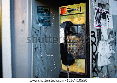 Old retro pay phone box on the street coin