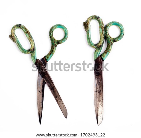 Old retro scissors with a blue handle on a white background. Isolated object