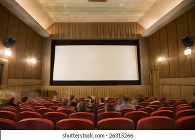 Old Retro Style Cinema Auditorium With Line Of Red Chairs, Sitting Visitors And Silver Screen. Ready For Adding Your Own Picture.