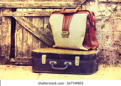 Old retro suitcases on wooden grunge a background. Old suitcases.