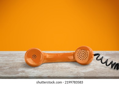 A Old Retro Telephone With The Receiver Off The Hook On A Table.