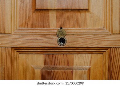 Old Retro Viewfinder In The Door, Eyelet In Wooden Door. The Concept Of Peeping, Security Against Cheaters And Burglaries.