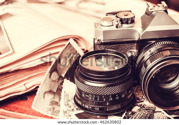 古いレトロなビンテージカメラと本の写真 アンティークレンズ装置 黒い被写体のフィルム写真 クラシックなクリエイティブ背景 表の画像 時代遅れのノスタルジアスタイル の写真素材 今すぐ編集 462630802