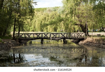 Old Rickety Wooden Bridge Over The Lake