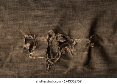 Old ripped jeans background. A detailed shot of a fragment of denim with holes. Creative background for various design tasks. Copy space. - Shutterstock ID 1743362759