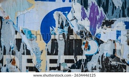 Old ripped torn posters texture background in city street