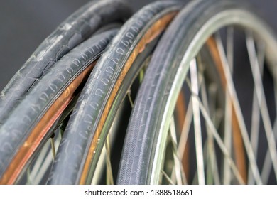 The old road bike wheels. Narrow worn tires. Spokes and rim close-up. Repairing a broken bicycle. A bicycle shop as a small business idea. Sports are the foundation of health. 