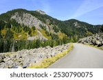 Old road climbing Snoqualmie Pass as National Forest NF 58 an alternative to Interstate 90 over rocky mountainside