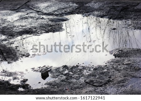 old road with a puddle