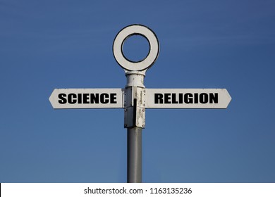 Old Road Sign With Science And Religion Pointing In Opposite Directions Against A Blue Sky