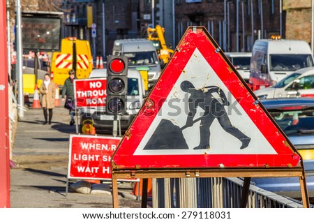 Old Roadworks Sign on a Busy Road in Scotland