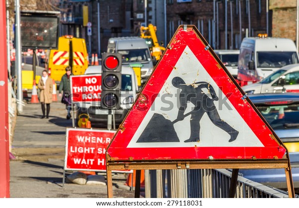 Old Roadworks\
Sign on a Busy Road in\
Scotland