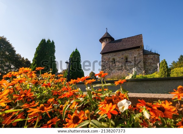 Old Romanesque church with flowers nearby. Velky Kliz,\
Slovakia. 
