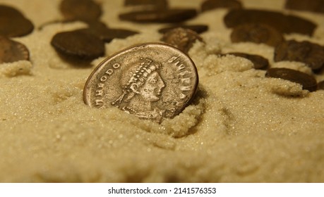 Old Rome coins copper in white wet sand  photo selective focus abstraction