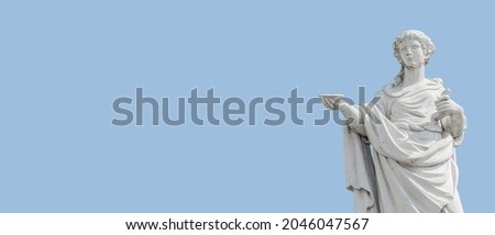 Old roof statue of a beautiful Renaissance Era woman philosopher and poet with a tea cup or food plate in Potsdam at white blue sky background and copy space, Germany