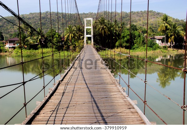 old rope bridge and wood to the island\
in Sukhothai,Thailand