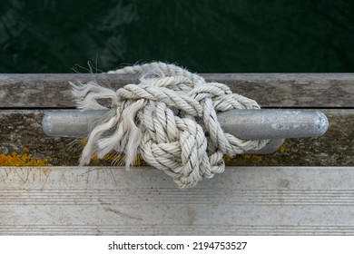 old rope on a metal cleat, sailing concept.