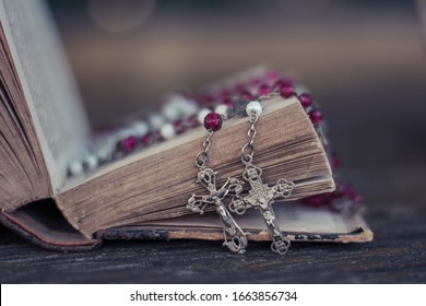 Old rosaries and open book - Shutterstock ID 1663856734