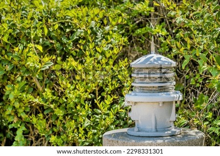 Old rotating beacon light once used in lighthouse.