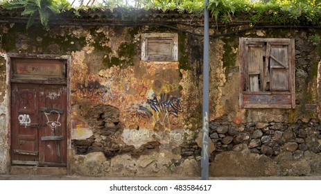 Old Rotten Wall Structure With Wooden Door And Graffitti