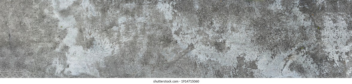 The old rough concrete floor has traces of dirty stains. - Shutterstock ID 1914715060