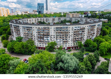 Old round residential building in Moscow in greenery. Summer, sunny day.