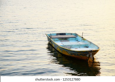 Old rowboat floating on the river without anyone else