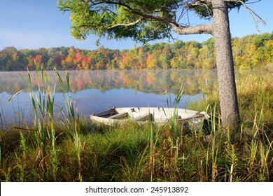 Old rowboat on the shore of a small Michigan lake in autumn.