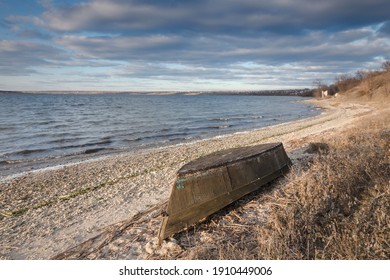 Old Rowing Boat On The River Bank. Gloomy Weather And Storm Clouds. Fishing On The River.