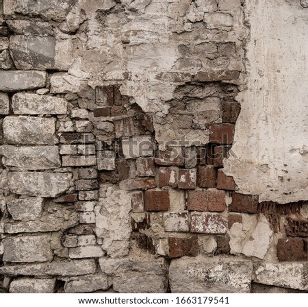 Old ruined historic protect wall. Shabby bumpy built front facade citadel. Worn damaged deserted partition of church courtyard. Vintage chipped spots stone mansion backyard. Grungy slum barrier for 3d