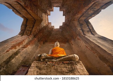 Old ruins of Wat Prasat Nakhon Luang or Nakhon Luang Palace in Phra Nakhon Si Ayutthaya province, Thailand. An old buddha statue in ancient temple. Famous tourist attraction landmark.