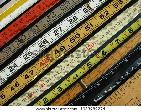 Old rulers both metric and inches, scales and measuring tools represent measurement, metrics, precision, accuracy and results.