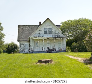 An Old Run Down, Weather Beaten Wood Siding House That Is In Need Of Repair.  What A Realtor Would Refer To As A Fixer-upper.