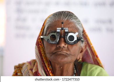 Old Rural Women From Rajasthan,India  Getting Her Eyes Checked. Vision Testing. Eye Health. Eye Care For Elderly. Old Women Wearing Eye Testing Frame. Eyesight Testing Tool. 