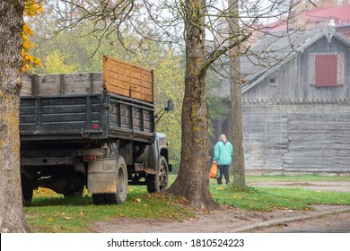 
An Old Russian Car With An Old Aunt And A House In The Fall