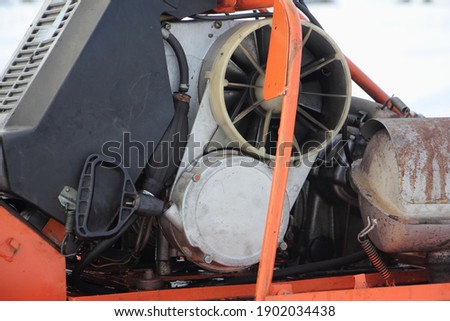Old Russian utility snowmobile two stroke  air cooled engine with emergency start engine handle close up