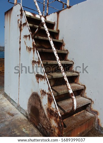 old rust stair on the ship in japan, white wall rust 